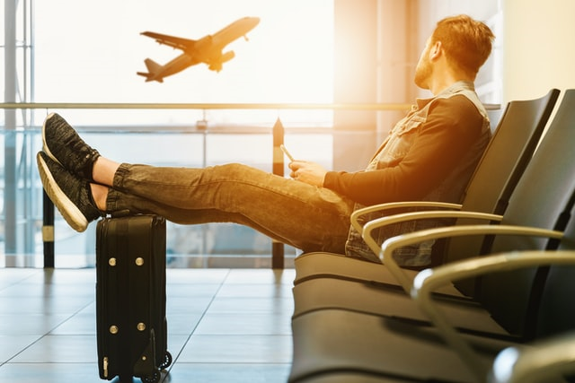 A man waiting for his flight during coronavirus global pandemic