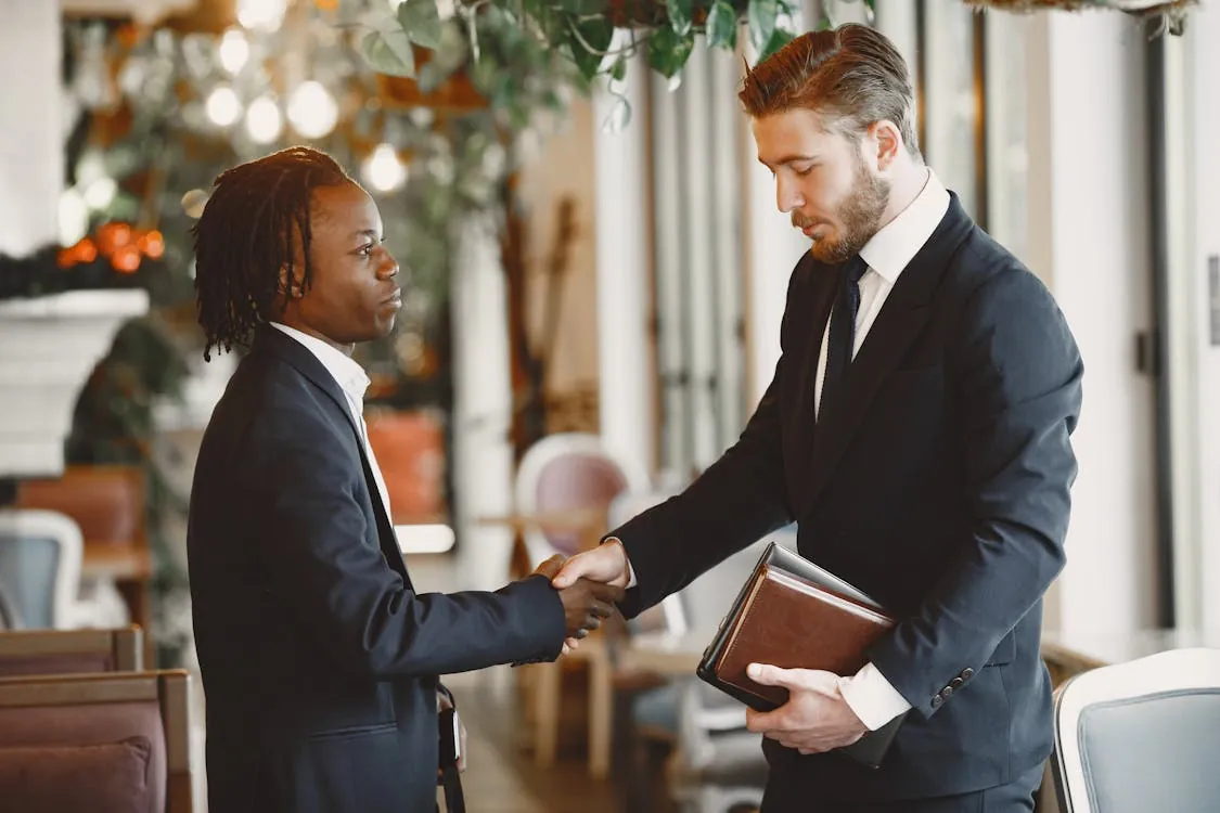 Chinese businesspeople shaking hands and meeting in a formal office