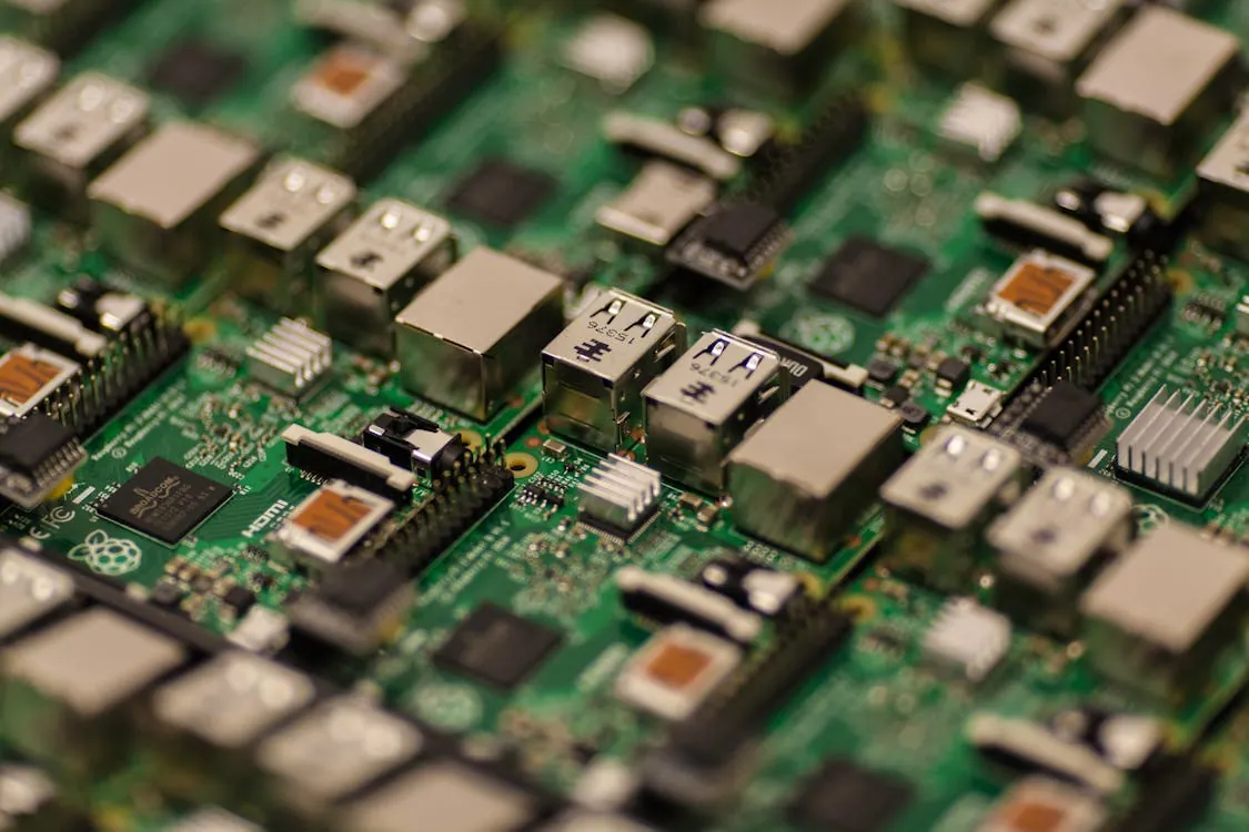 Close-up of a green printed circuit board with electronic components.