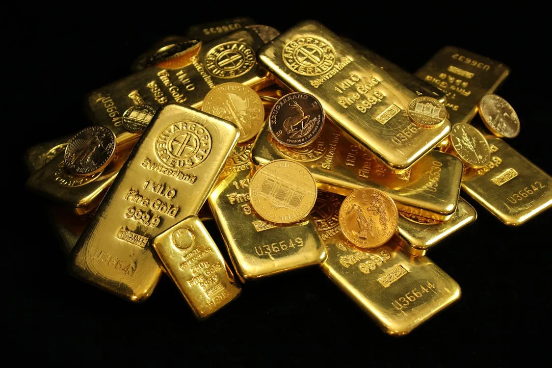 Gold bars and coins on a dark background