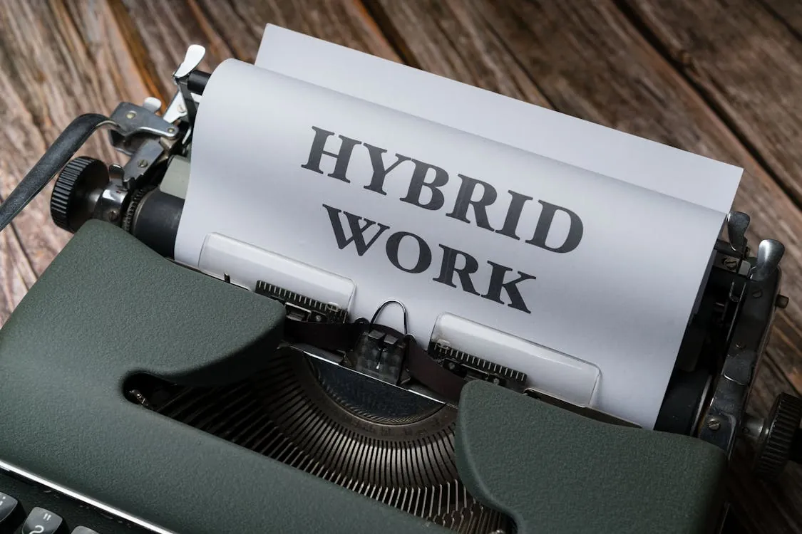 Retro typewriter with 'Hybrid Work' text, symbolizing modern work trends.