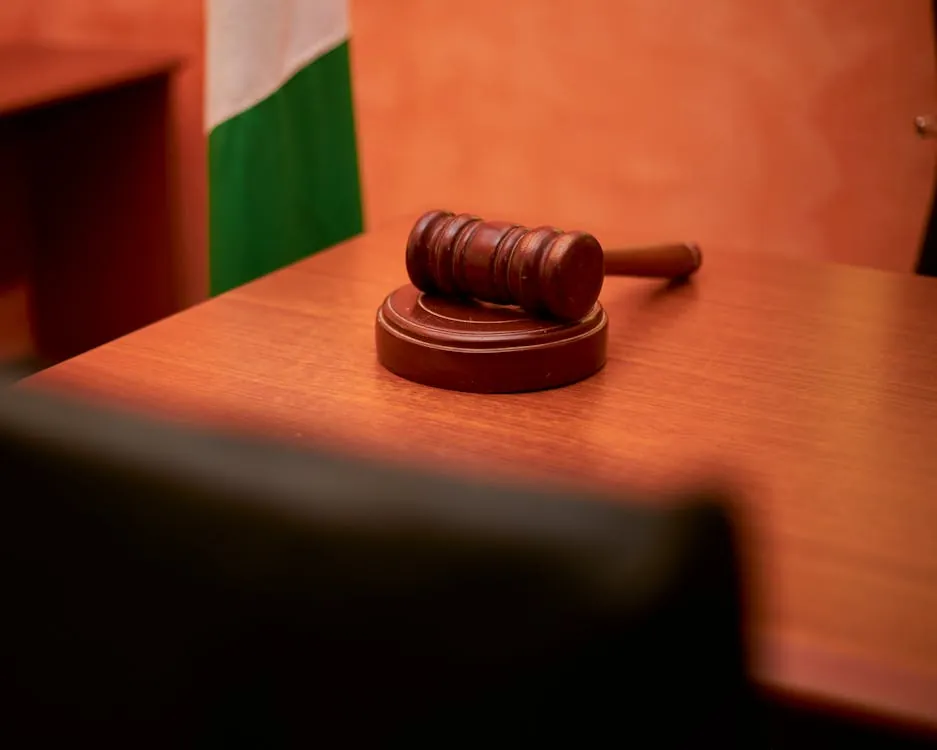 A close-up of a gavel on a courtroom desk representing law and justice, symbolizing the legal framework for VPN use in China.