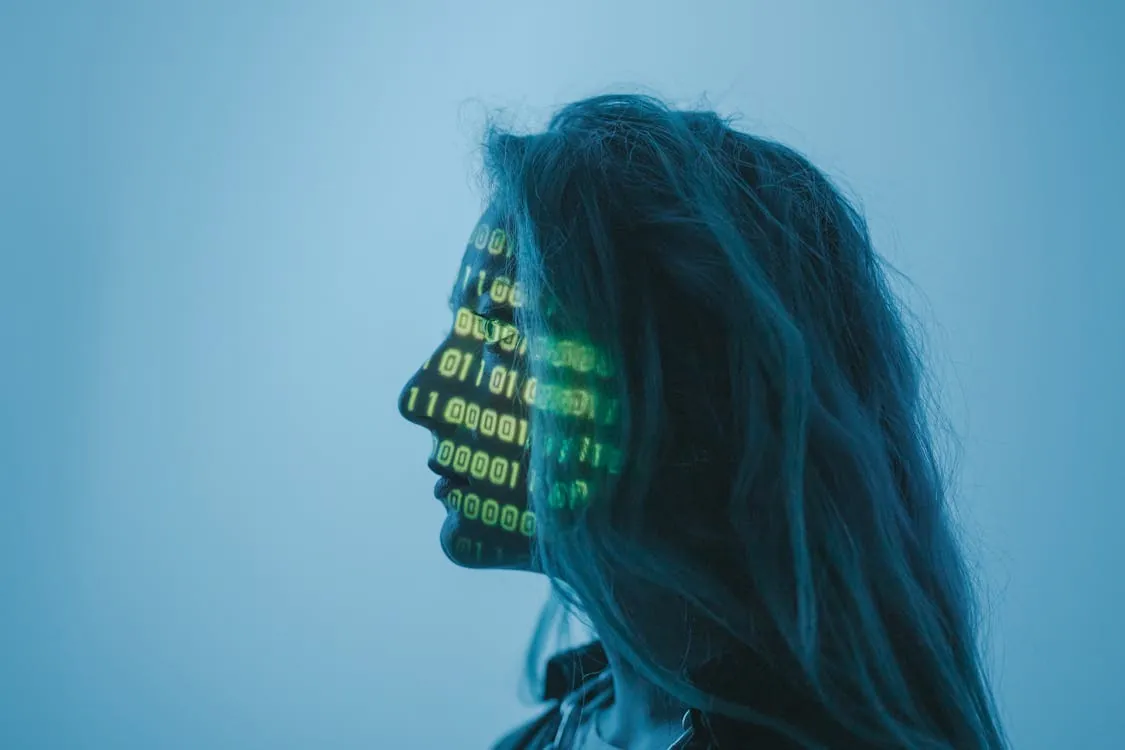 Silhouette of a woman with binary code projected on her face in a digital concept setting, representing multimodal AI benchmarks.