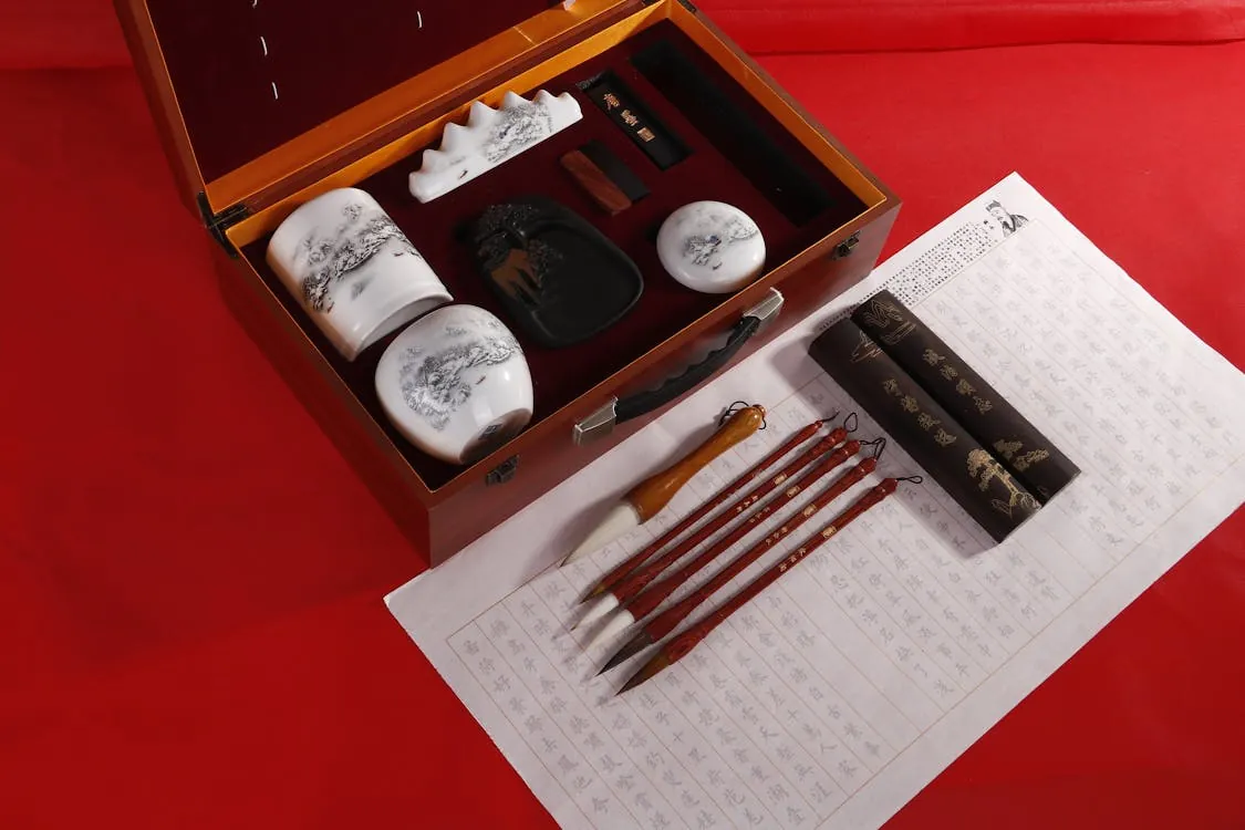 Elegant Chinese calligraphy set with brushes and ink, symbolizing the cultural origins and significance of Chinese calligraphy.