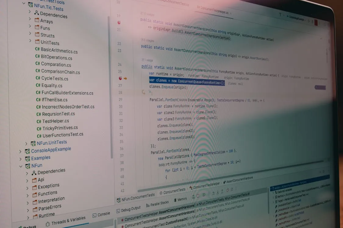 The photo shows a close-up of a computer screen displaying a code editor with programming code written in C#, alongside a sidebar of project directories and files related to unit testing. This image would suit an article about software development, coding practices, or debugging processes.