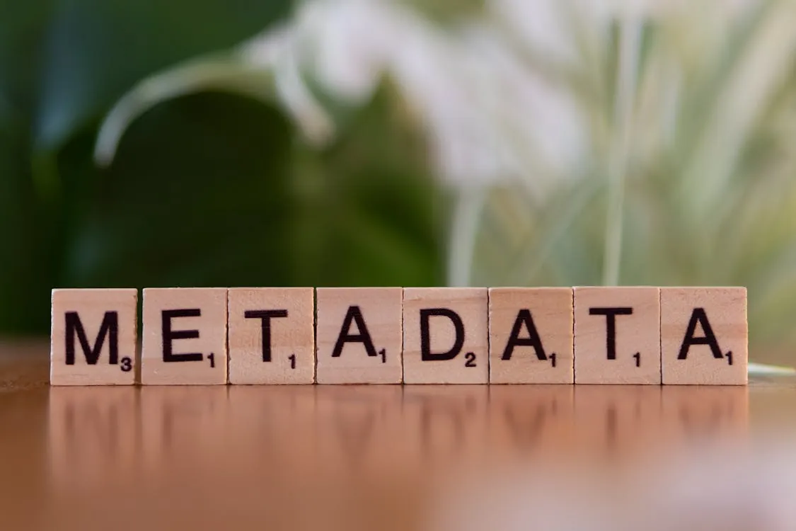 Wooden tiles spelling 'METADATA', symbolizing hash index data organization