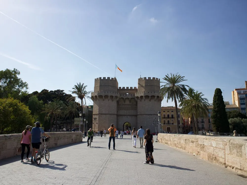 Historic Valencia urban scene with families and cyclists