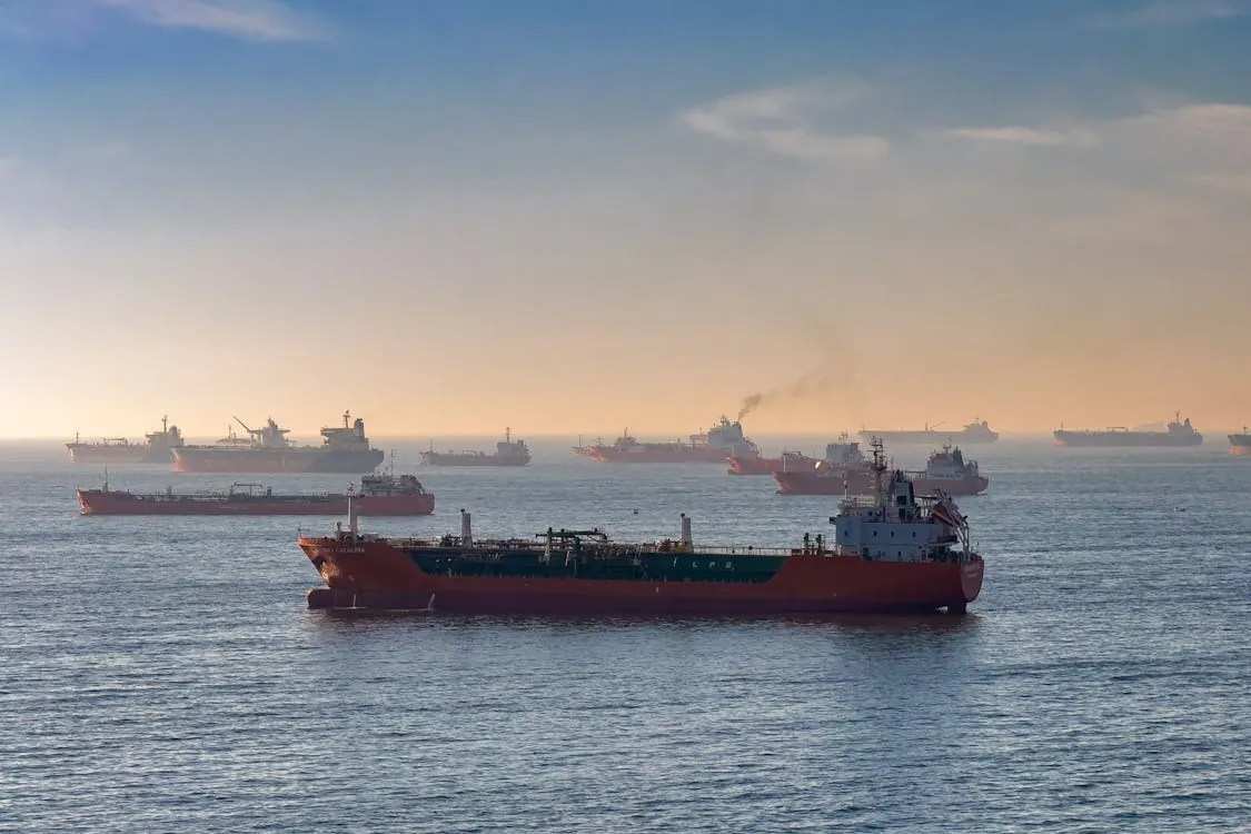 Cargo ships anchored at sea representing global shipping and oil trade routes