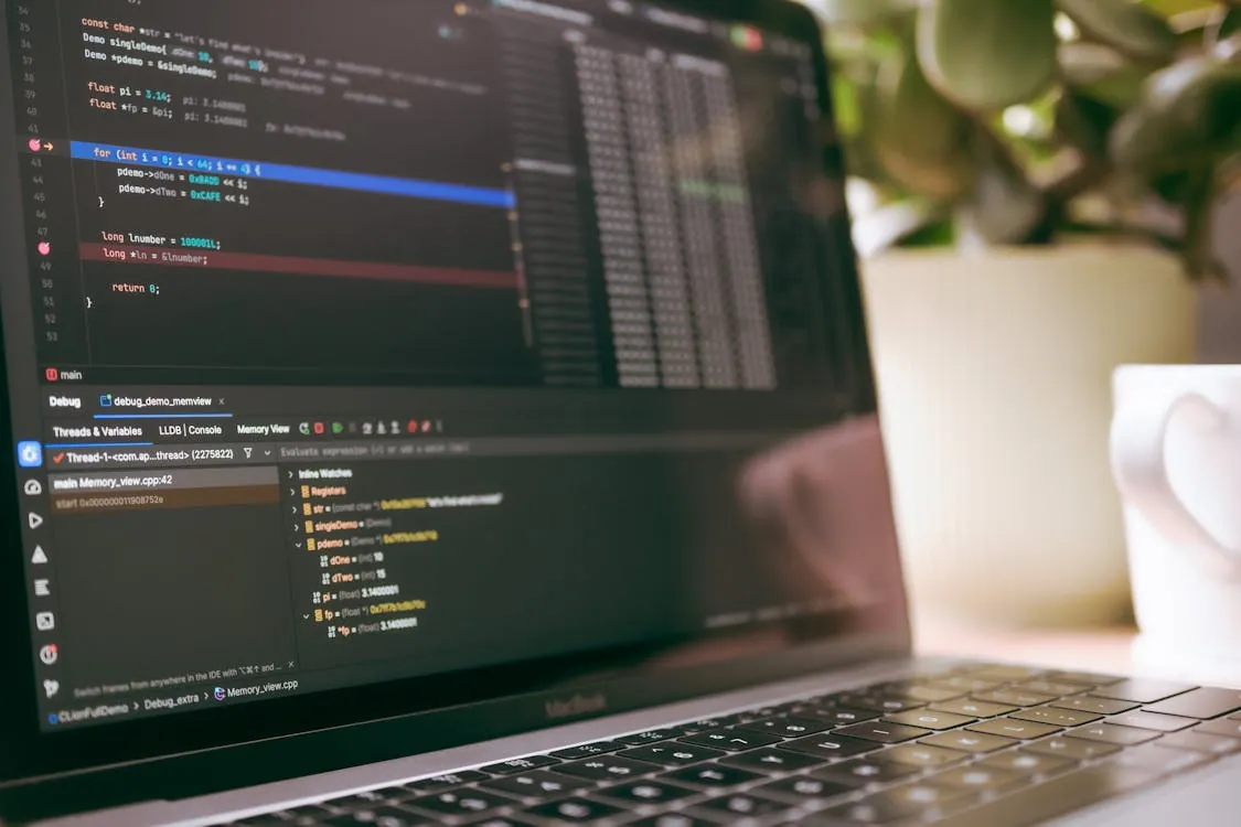 Developers debugging code on a laptop