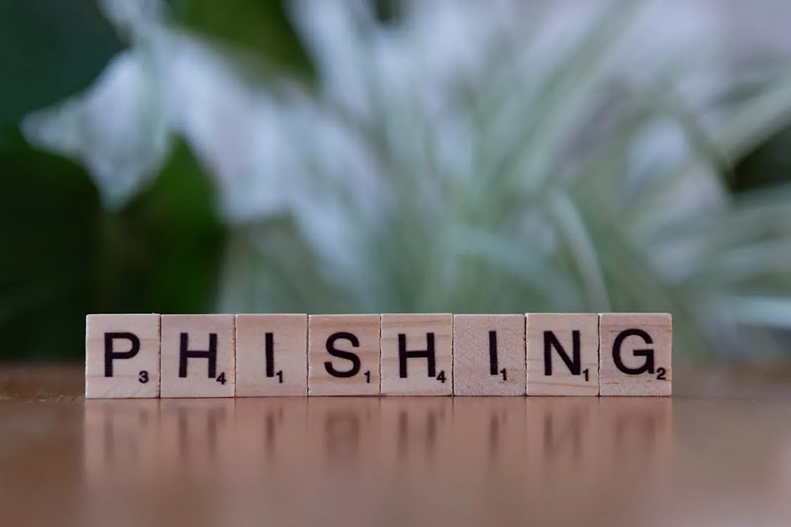 Scrabble tiles spelling 'PHISHING'