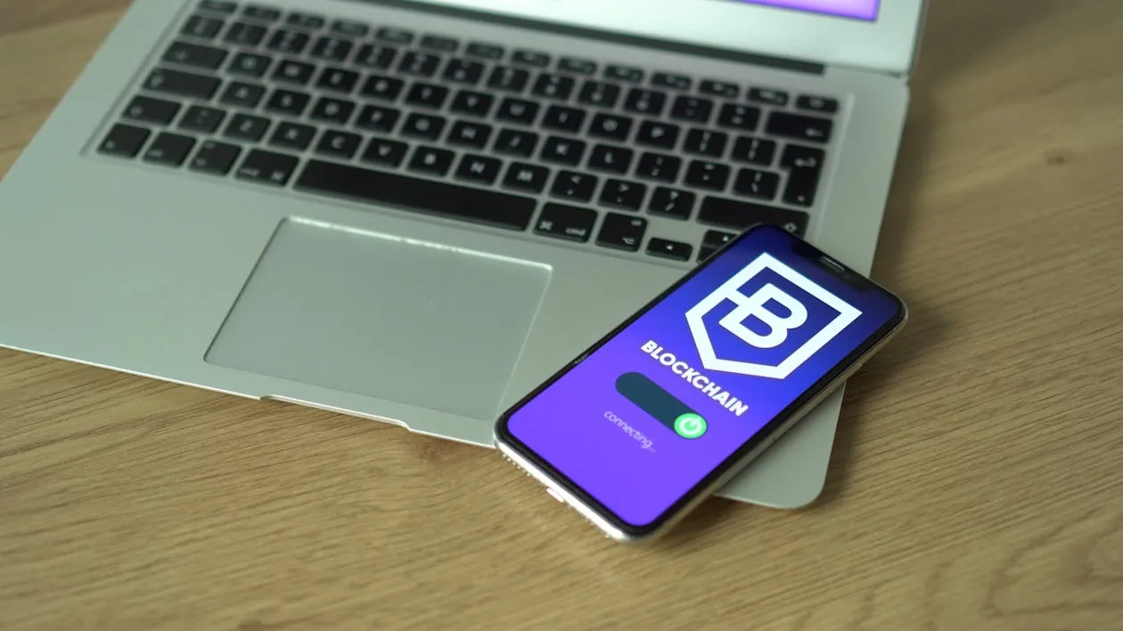 Laptop and smartphone showing blockchain security apps