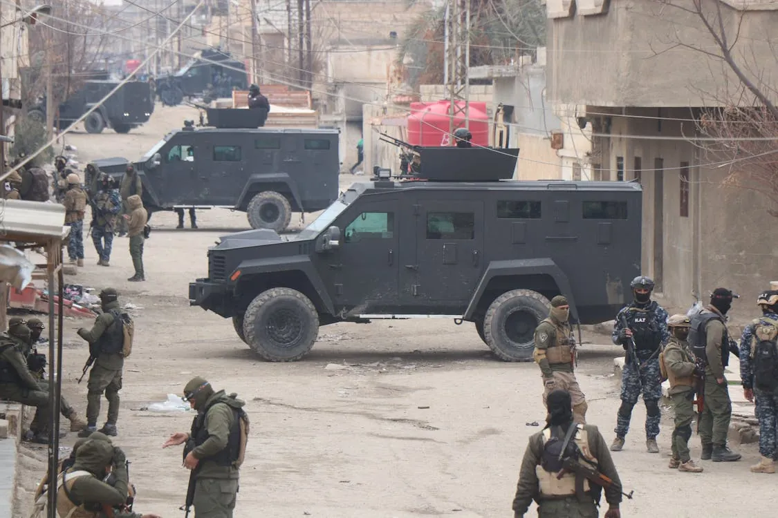 Armored military vehicles operating in a Middle Eastern urban area during heightened regional tensions