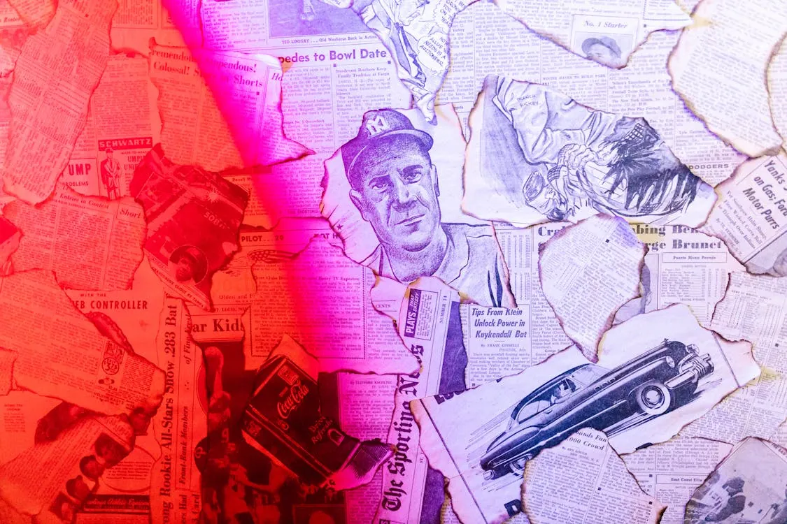 This image features torn newspaper clippings layered together, with a sketch of a man in a baseball cap at the center, and a vintage car illustration at the bottom right. The photo's vibrant pink and red lighting creates a dramatic, nostalgic atmosphere, making it suitable for articles about journalism, media history, or retro culture.