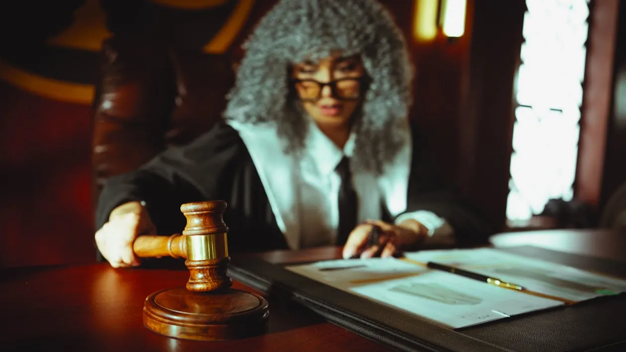 Busy courtroom with judges and legal clerks overwhelmed by case filings