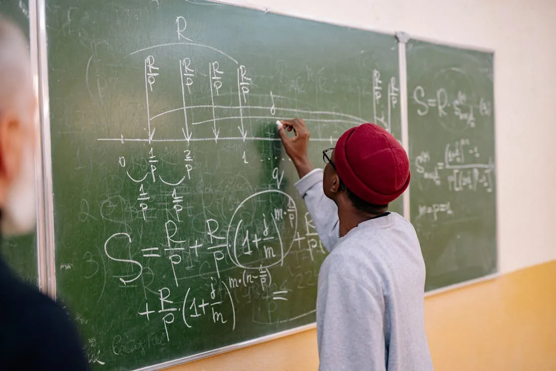 Mathematician writing proofs on paper with formulas