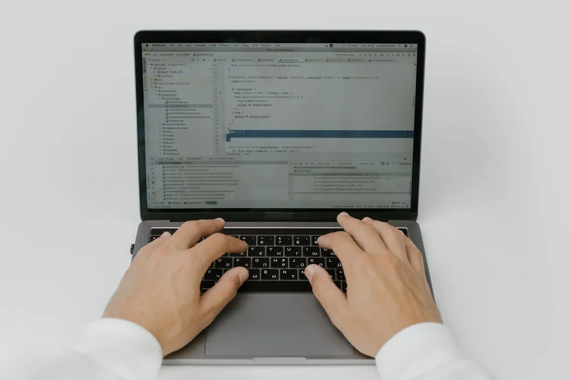 Software engineer coding on laptop