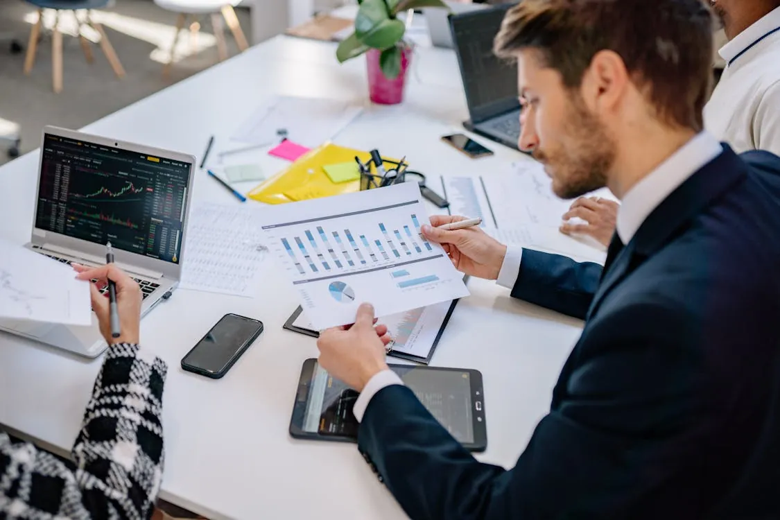 Enterprise software team reviewing financial graphs for valuation analysis