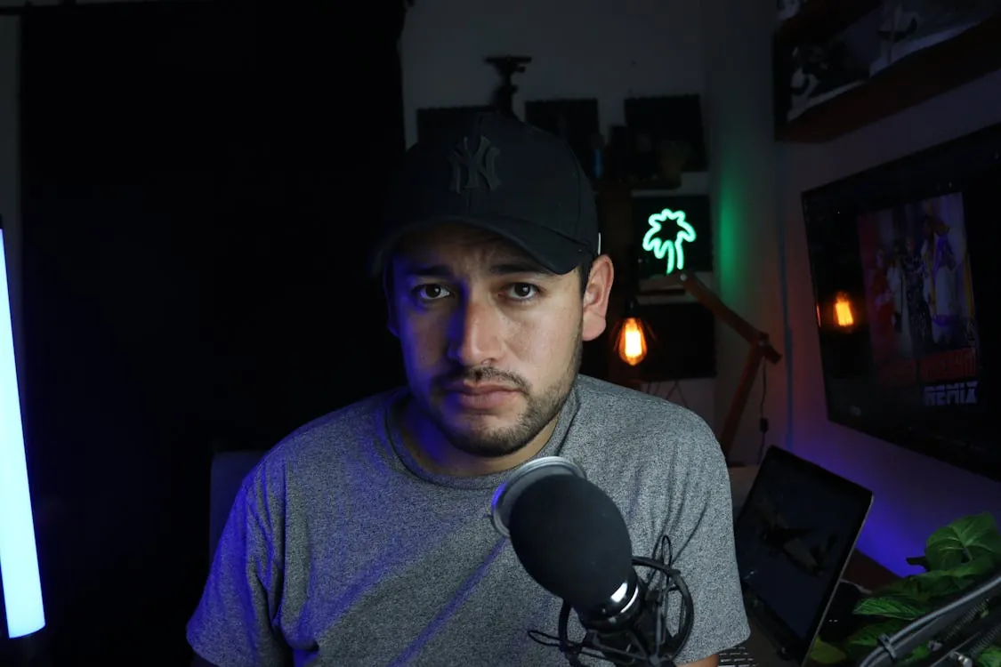 YouTube content creator in studio setup with camera and microphone.