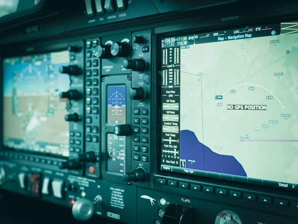 Airplane cockpit navigation display showing GPS coordinates