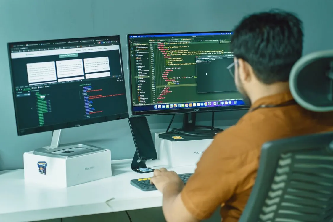 Developer comparing AI inference engines on a workstation with dual monitors