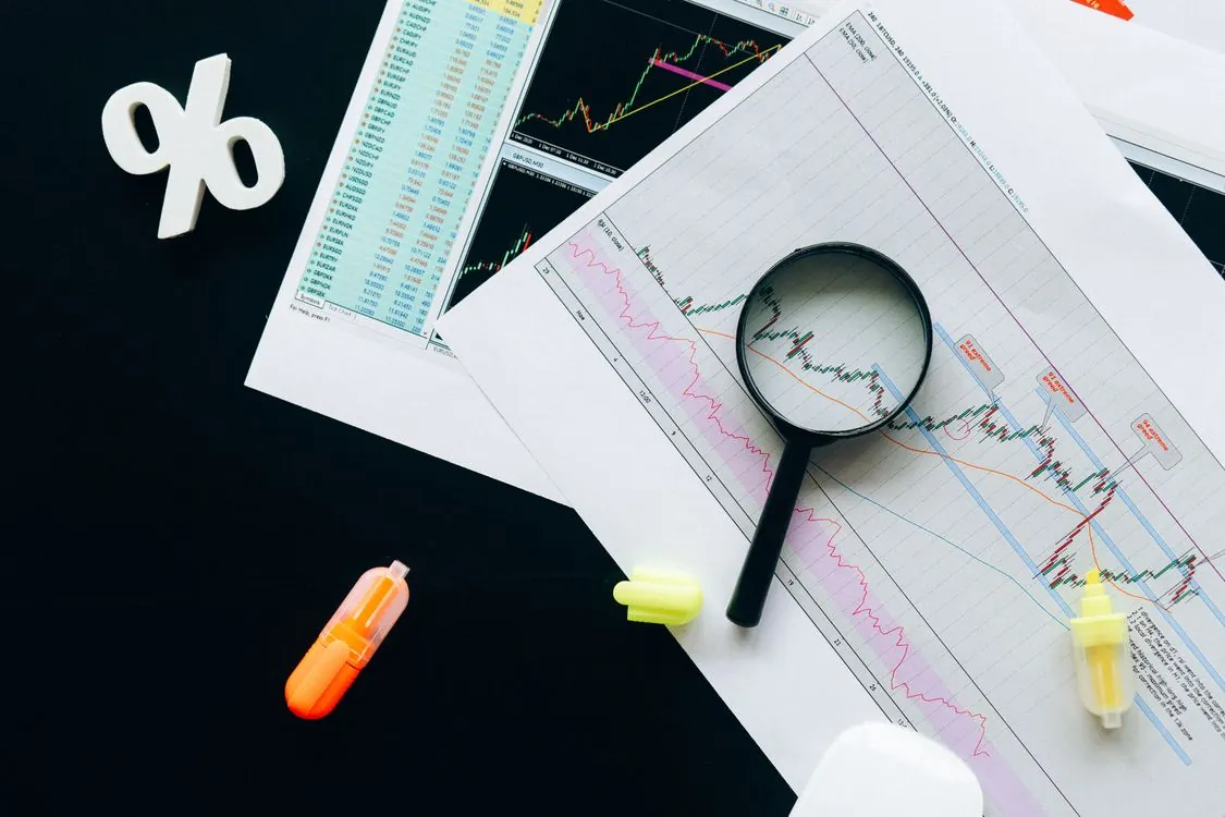 Trading desk with financial market charts for emerging market bond analysis