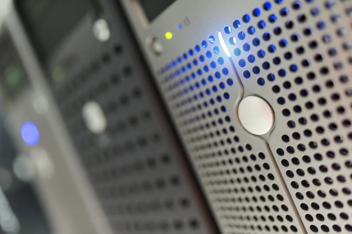 Rows of server racks in a modern data center with blue LED lighting