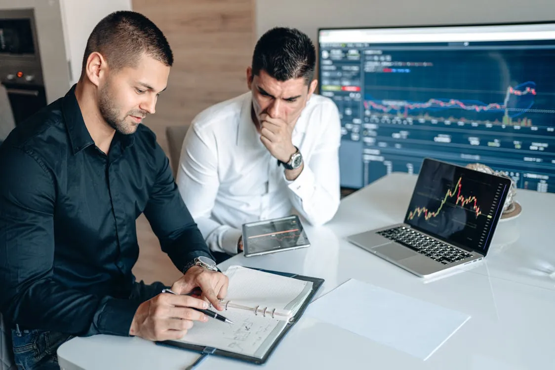 Financial analysts reviewing market charts in an office