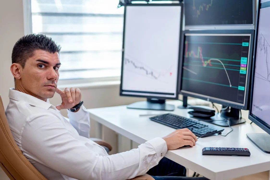 Financial analysts reviewing market data and software valuation charts