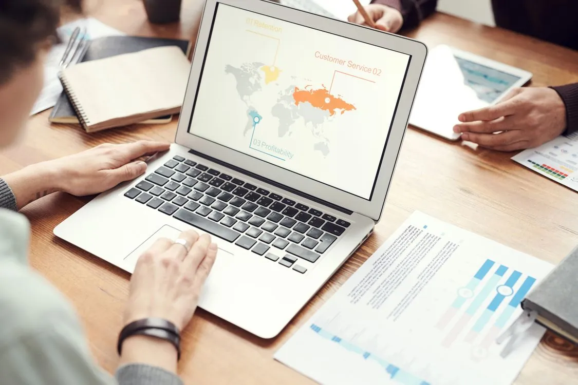 Business professionals collaborating across a digital world map