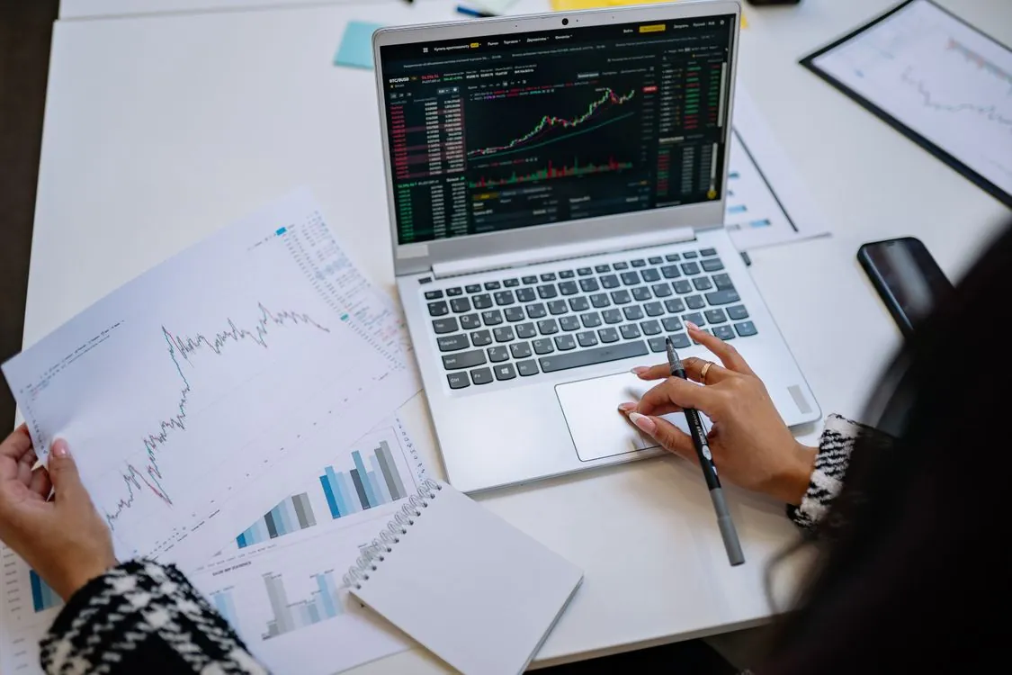Investor reviewing financial charts on a laptop