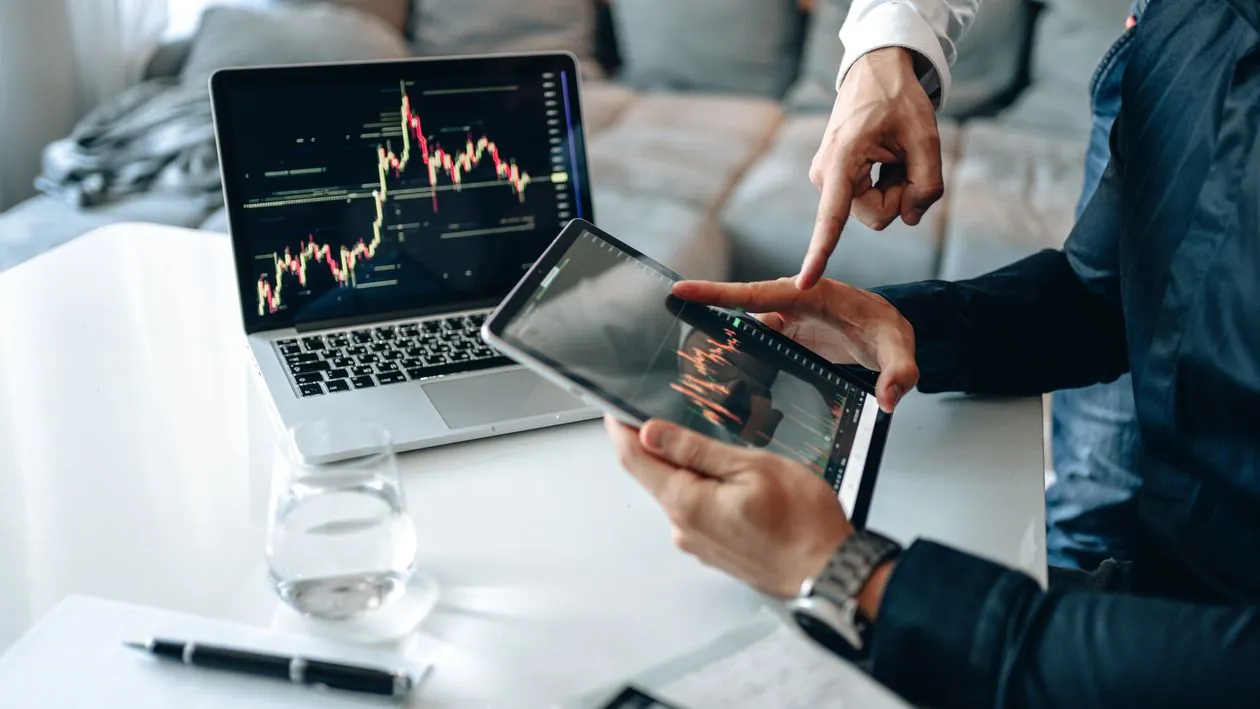 Professional analyzing financial charts on a laptop representing market position and stock performance in 2026