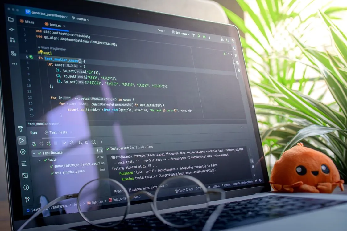 Laptop screen showing code editor with software development workflow