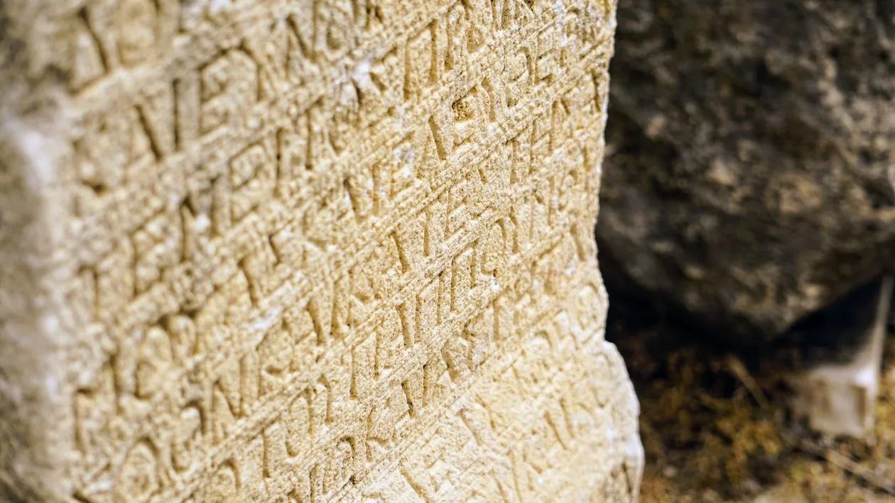 Close up of ancient Roman stone inscription with carved letters showing scribal abbreviations