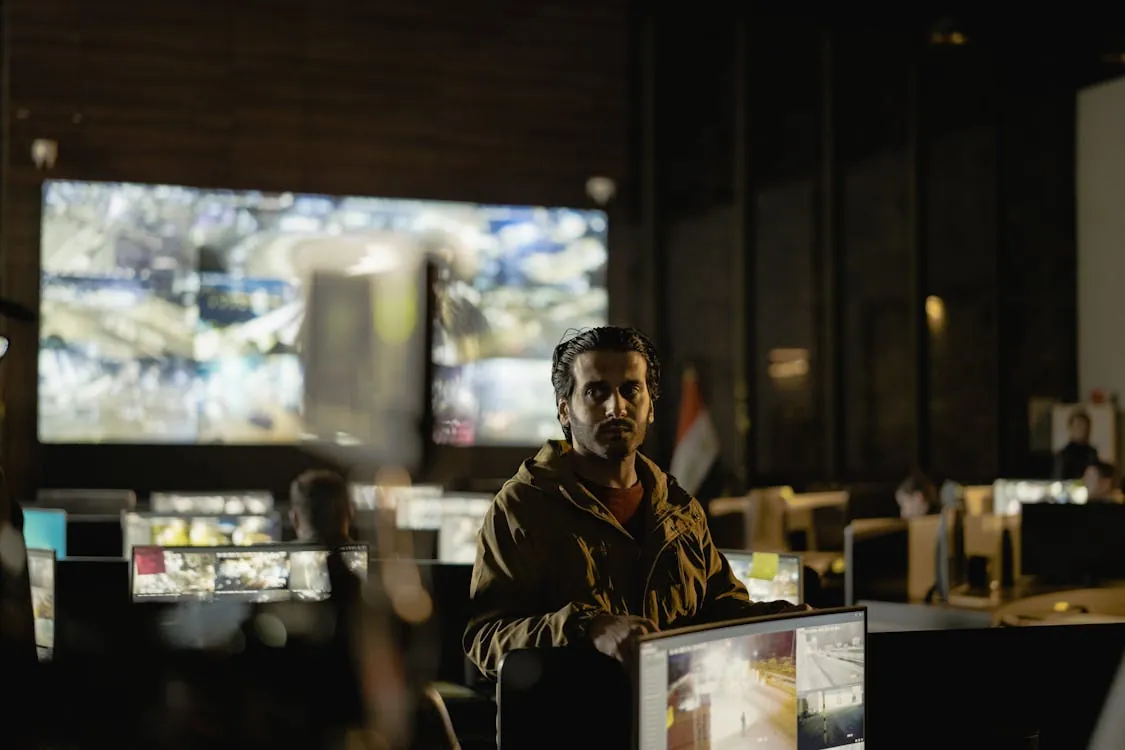 Security team monitoring network traffic and threats on multiple screens
