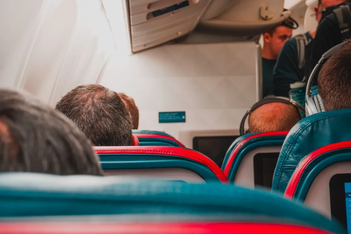 Interior view of airplane cabin with passengers seated