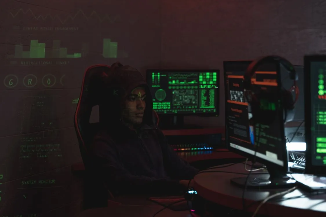 Security researcher analyzing malware on multiple monitors