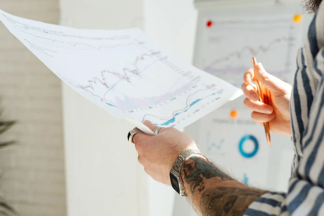 Financial analyst reviewing company filings and market charts