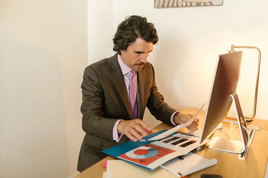 Financial analyst reviewing tech company filings and market charts