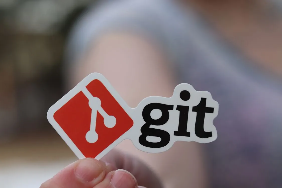 Git logo sticker held in hand representing version control