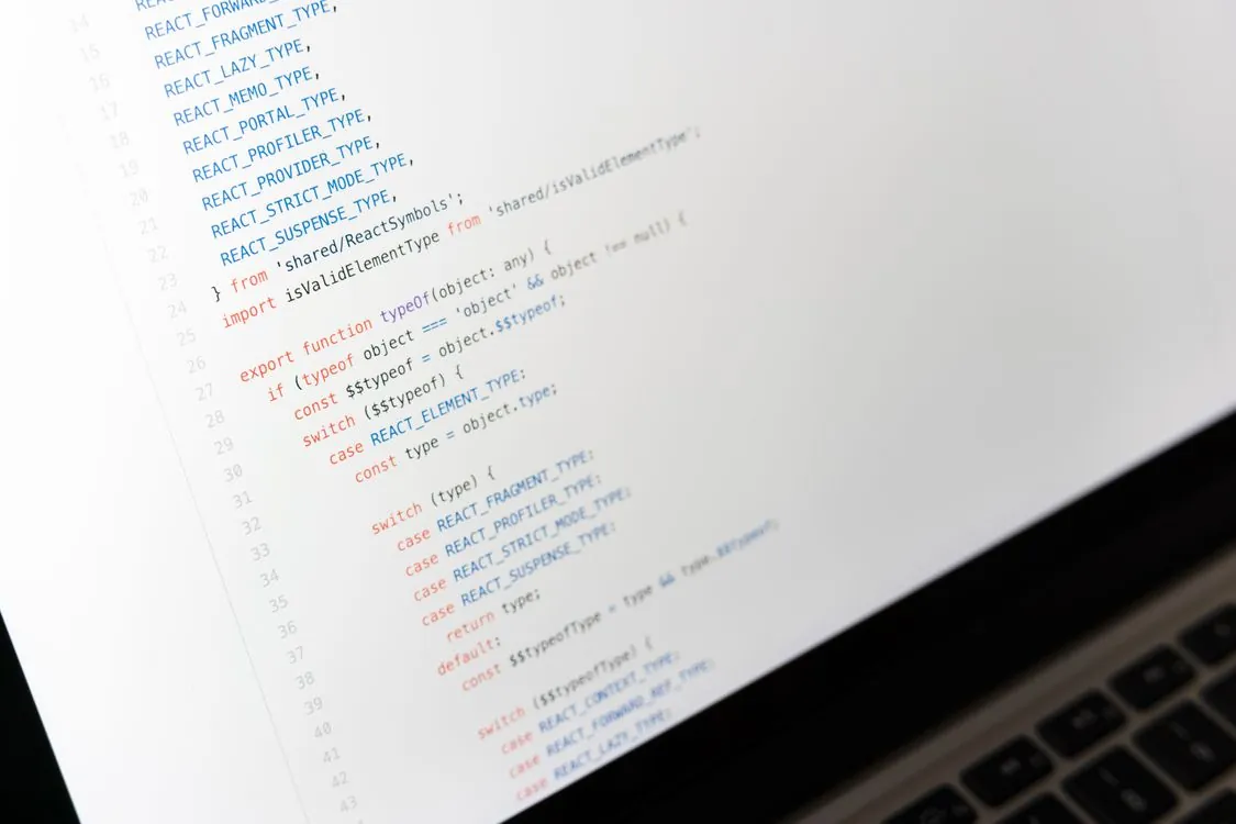 Developer writing JavaScript code on laptop screen