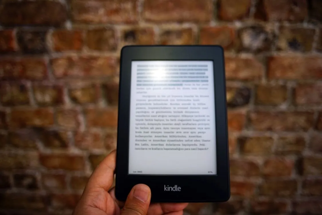Amazon Kindle e-reader on desk showing e-book reading screen