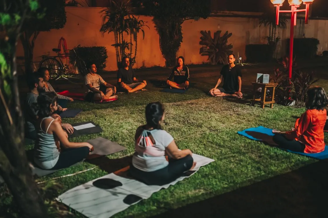 Group of people doing yoga outdoors at a wellness event