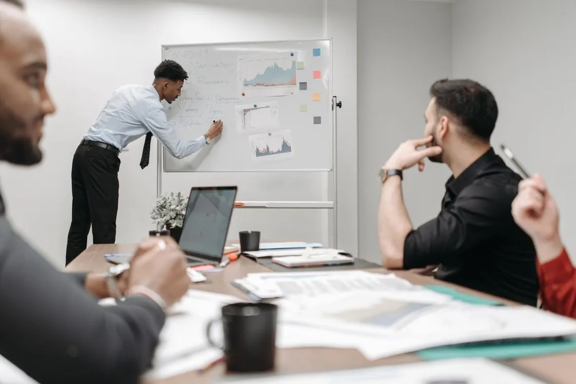 Business team working on data protection compliance strategy with checklists on whiteboard