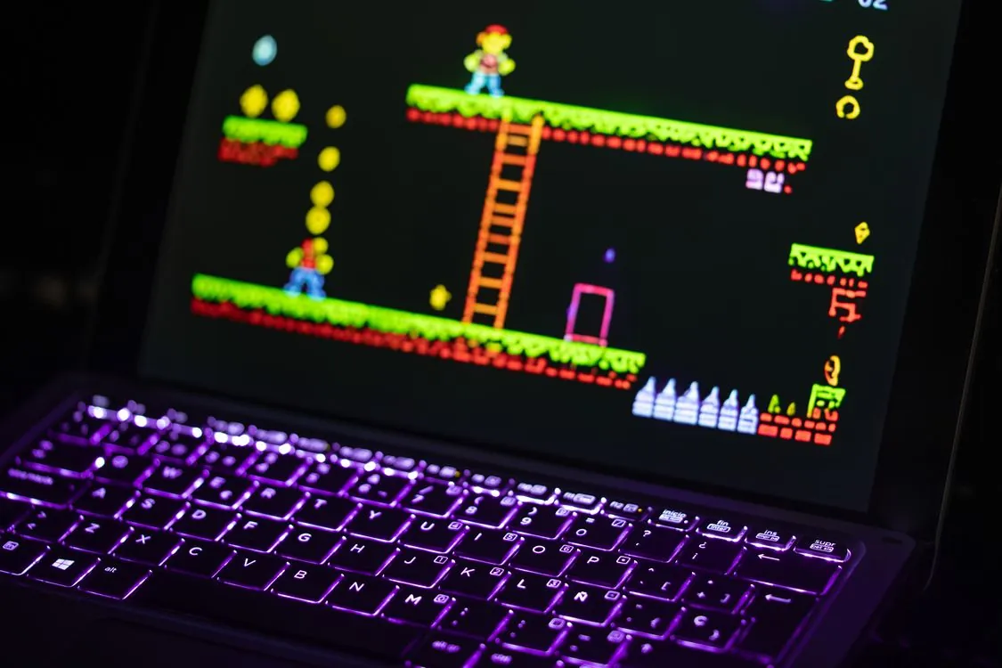 Retro pixel art platformer game running in web browser on laptop