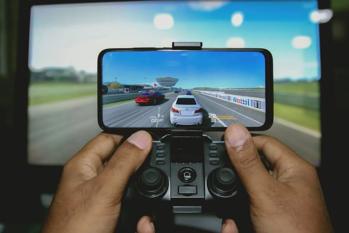 Smartphone displaying retro video game emulator with classic game graphics