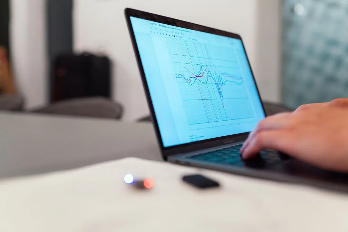 Engineer analyzing AI model performance data on computer monitor