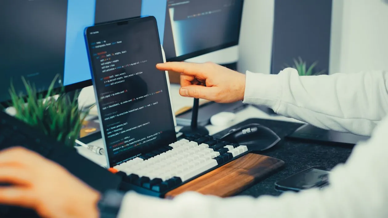 Developer writing SQL migration code on a laptop