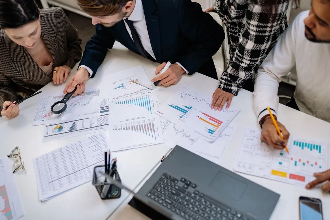 Engineers and finance team reviewing infrastructure cost charts and budget projections