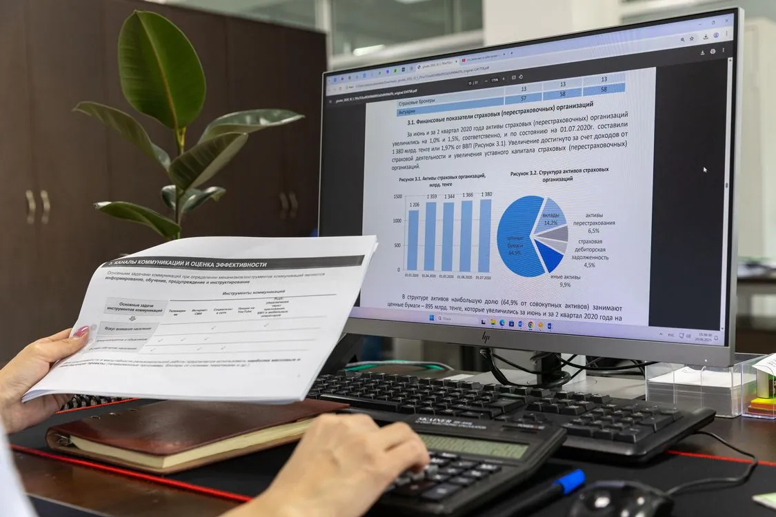 Financial analyst reviewing invoice documents on a computer screen