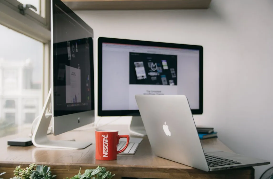 Mac laptop on a modern office desk representing a small managed Mac fleet